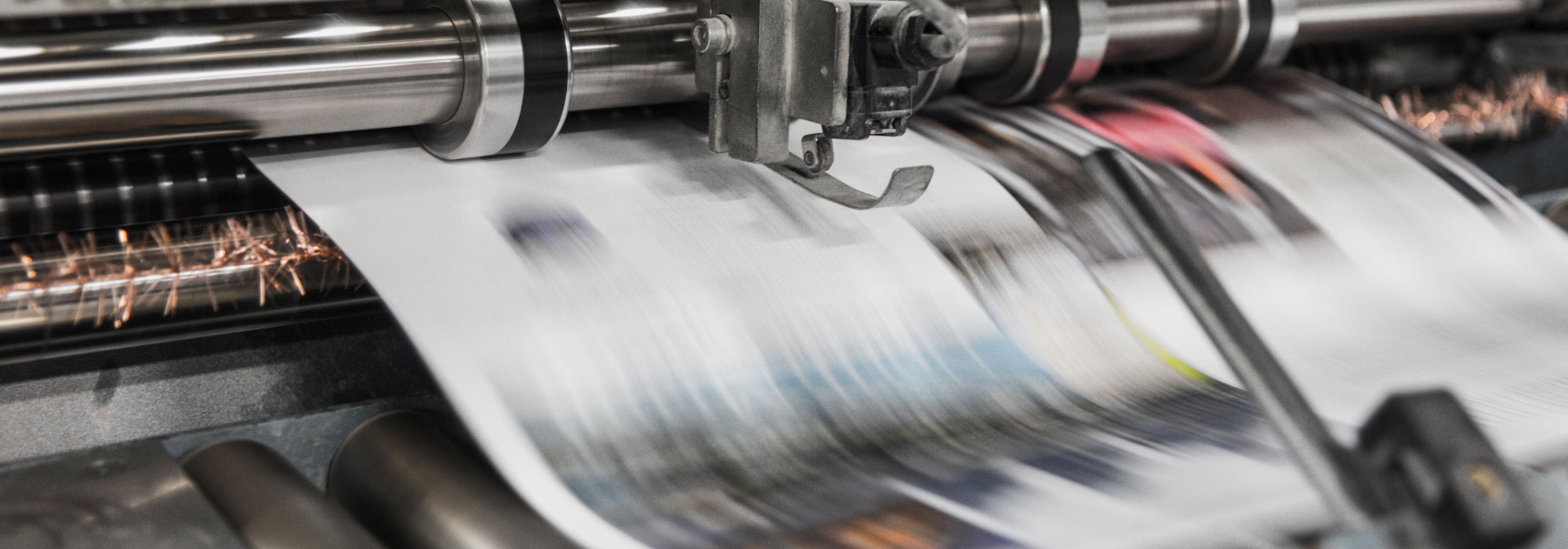 Large sheet of paper coming through industrial printer